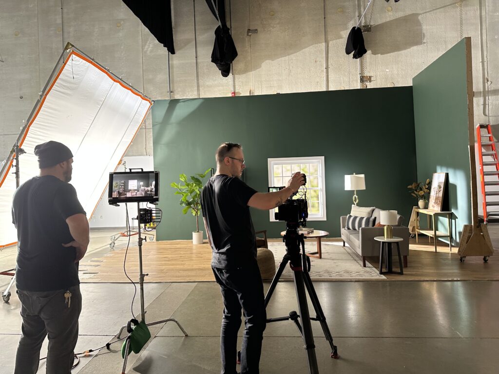 A professional Chicago instructional videographer team from Beverly Boy Productions sets up camera and lighting for the Target instructional video shoot in a Chicago studio.